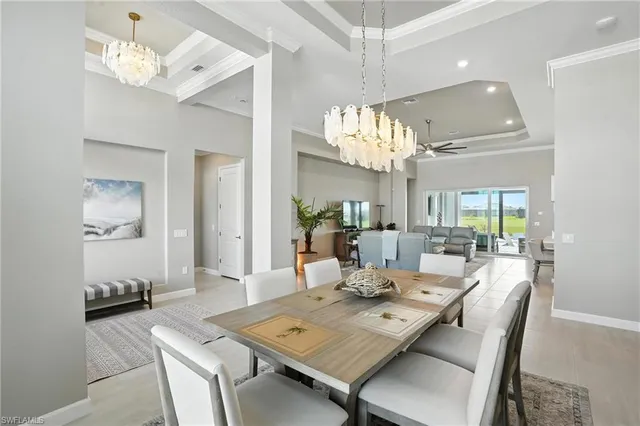 a view of a dining room with furniture a chandelier and wooden floor