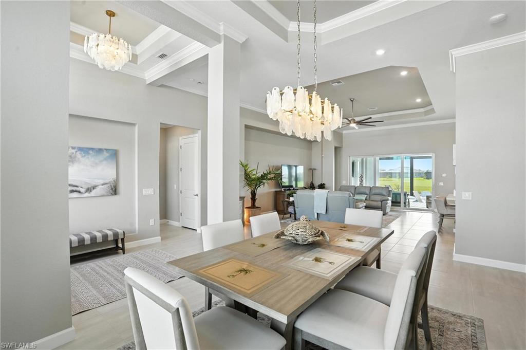 15027 Longs Lane Babcock Ranch, FL 33982 - Photo 8 of 50 a view of a dining room with furniture a chandelier and wooden floor