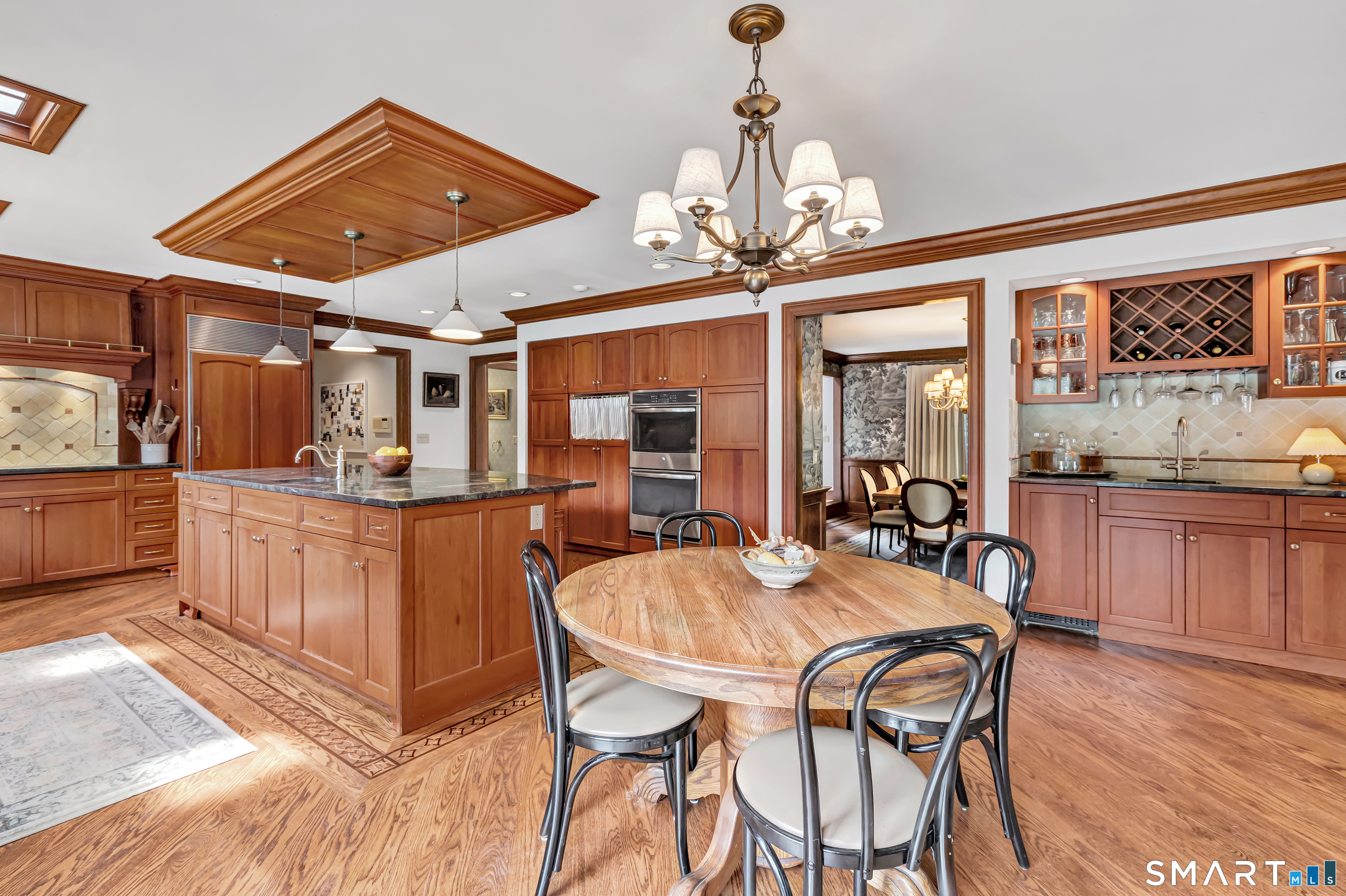 17 Plumtrees Road Newtown, CT 06470 - Photo 11 of 40 Plenty of places to sit, with counter seating at the large island or the perfect spot for a casual dining area. And a wet bar with ice maker near the dining room