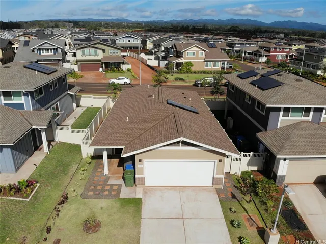an aerial view of a house with a yard
