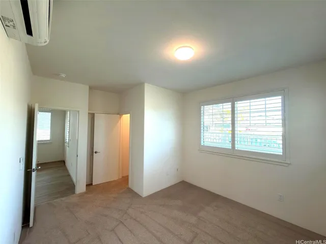 an empty room with windows and closet