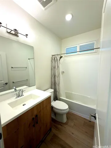 a bathroom with a sink mirror toilet and shower