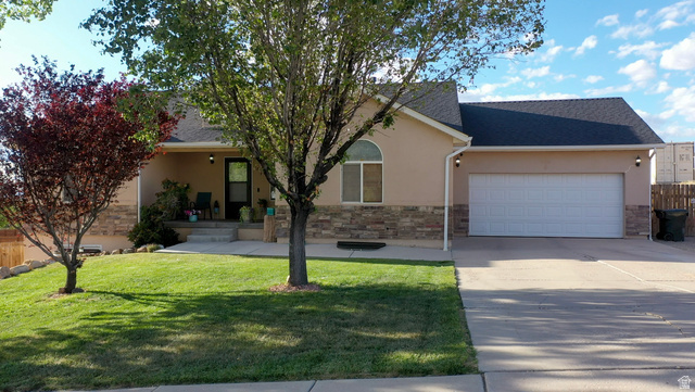 1797 Sunset Road Enoch, UT 84721 - Photo 76 of 80 Stucco exterior with stone accenting, an arched window, and a covered front porch
