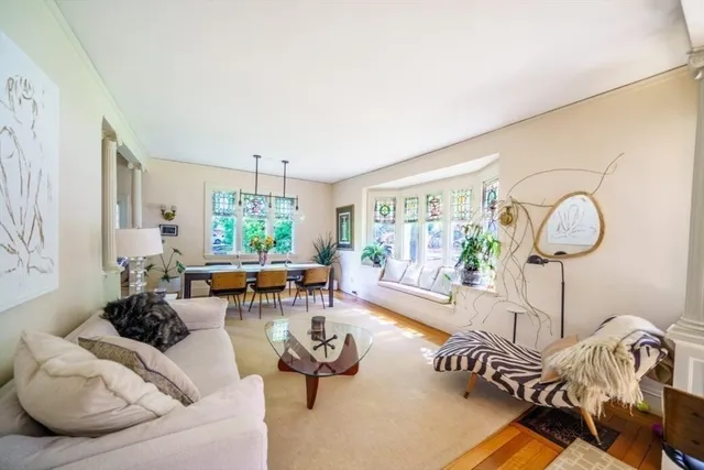 a living room with furniture chess table and a window