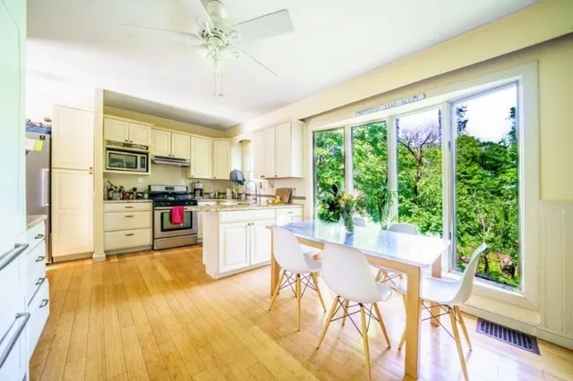 a kitchen with a table chairs refrigerator and cabinets