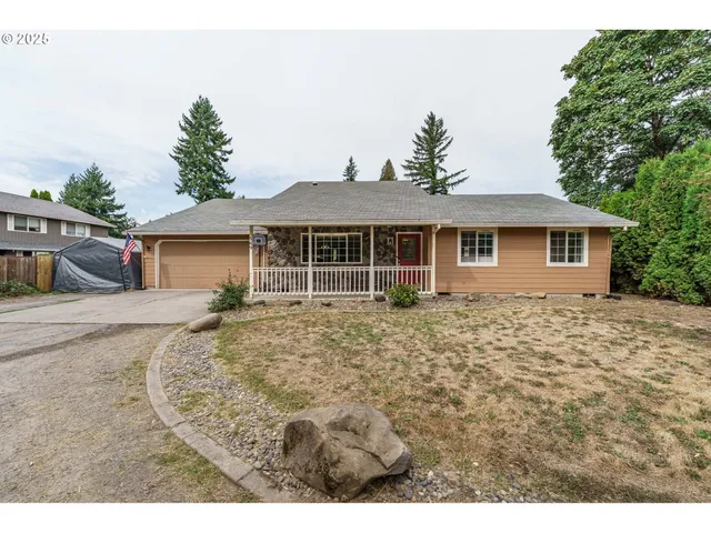 a front view of a house with a garden