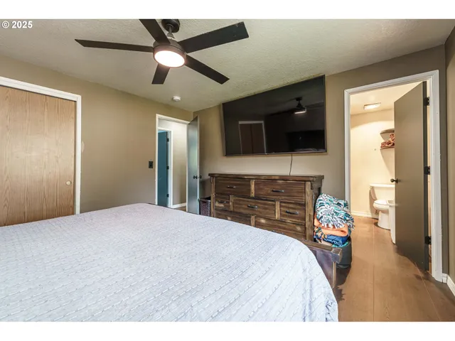 a bedroom with a bed and a flat screen tv