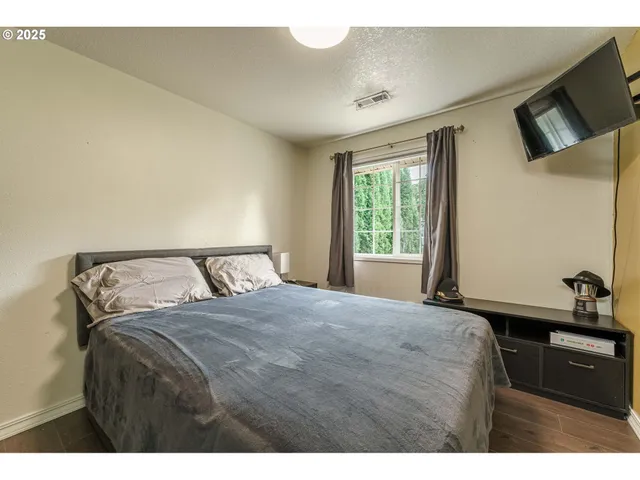 a bedroom with a bed and a tv