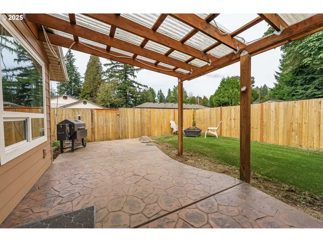 a view of a backyard with plants and a patio