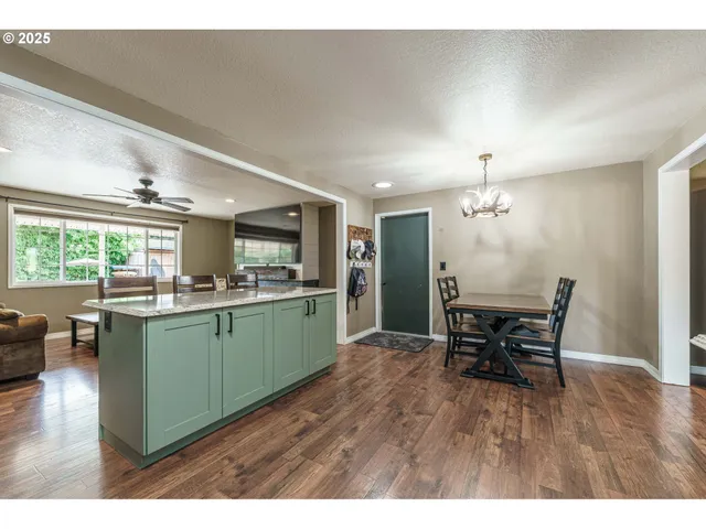 a kitchen with furniture and wooden floors