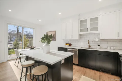 a view of a kitchen area with furniture and wooden floor