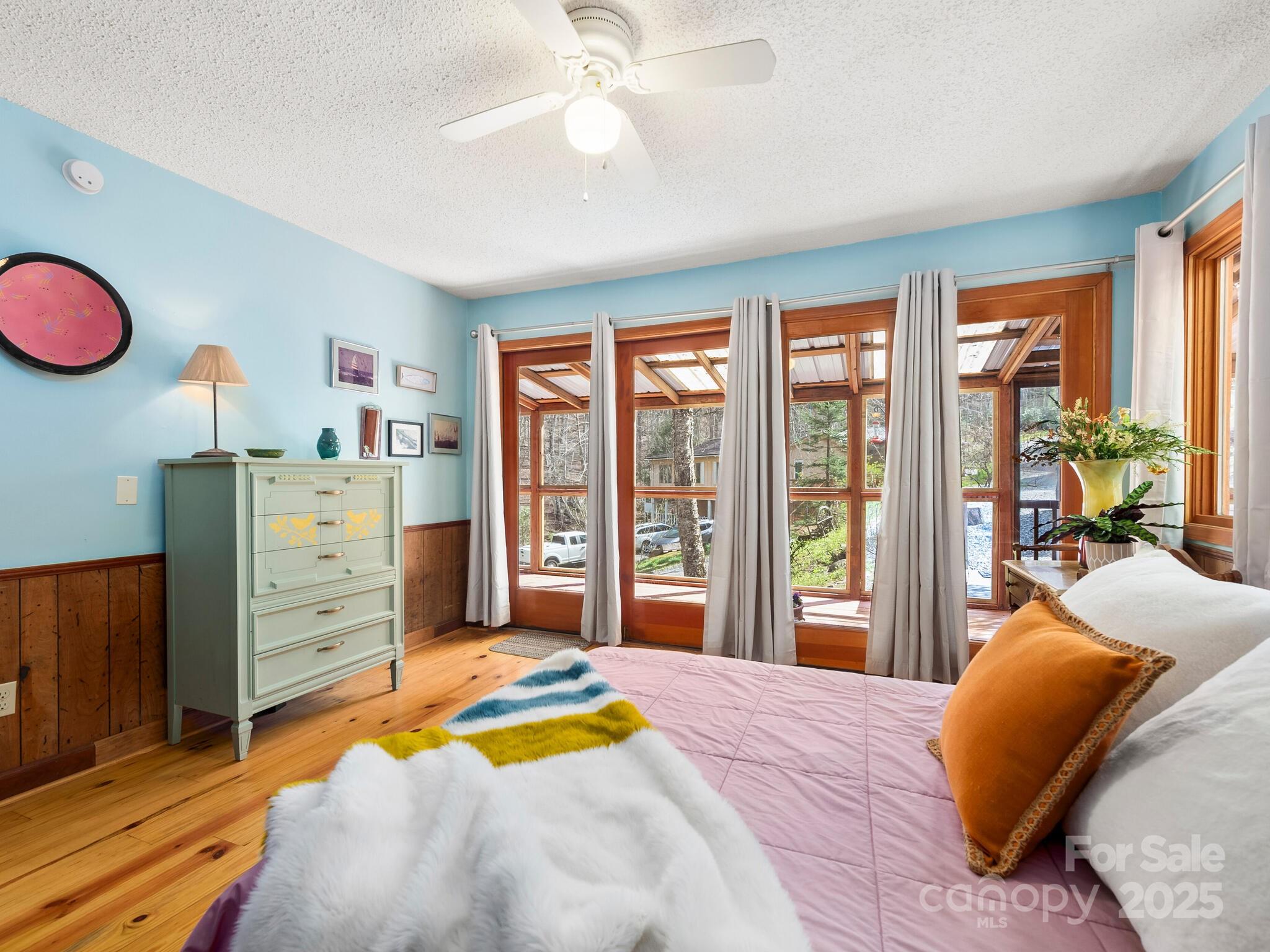 70 Fox Run Hot Springs, NC 28743 - Photo 12 of 29 a bedroom with a bed and a chandelier