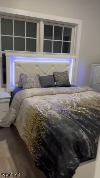 197 12th Avenue, Unit 201 Paterson, NJ 07501 - Photo 15 of 15 a bedroom with a bed and a window