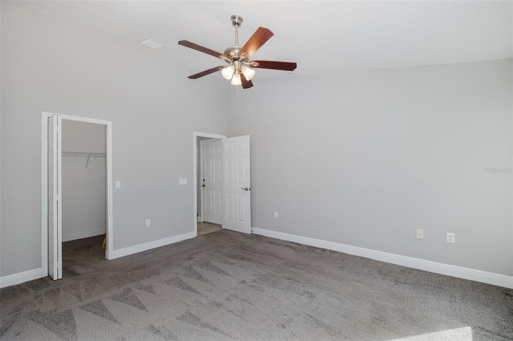 6823 Crossbow Lane New Port Richey, FL 34653 - Photo 11 of 25 an empty room with closet and a chandelier fan