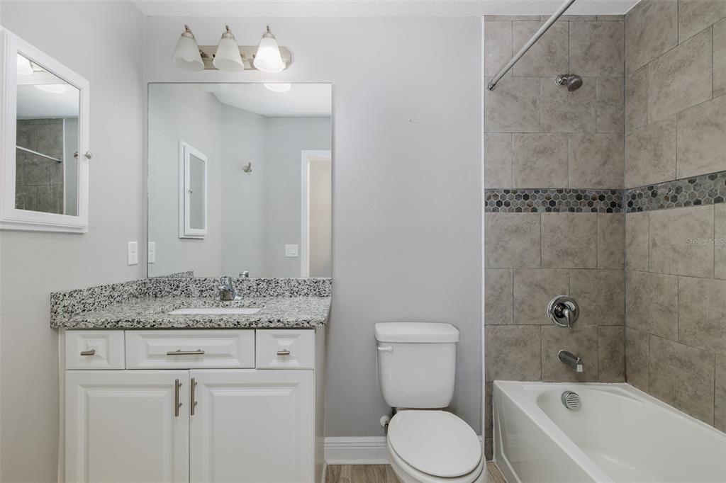 6823 Crossbow Lane New Port Richey, FL 34653 - Photo 15 of 25 a bathroom with a sink toilet and shower
