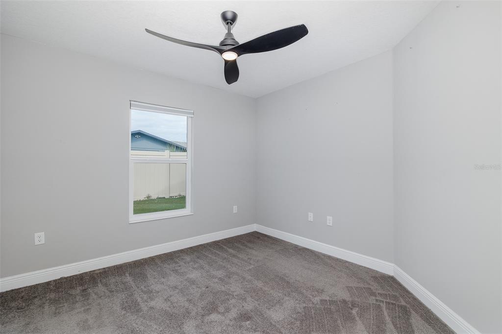 6823 Crossbow Lane New Port Richey, FL 34653 - Photo 18 of 25 an empty room with a window and a fan