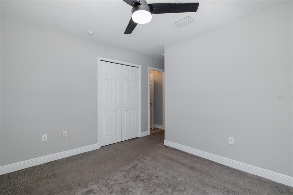 6823 Crossbow Lane New Port Richey, FL 34653 - Photo 19 of 25 an empty room with a ceiling fan