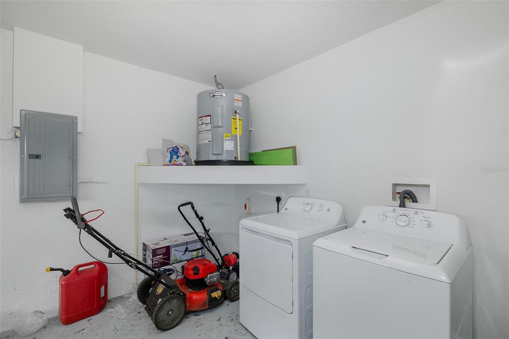 6823 Crossbow Lane New Port Richey, FL 34653 - Photo 21 of 25 a utility room with dryer and washer