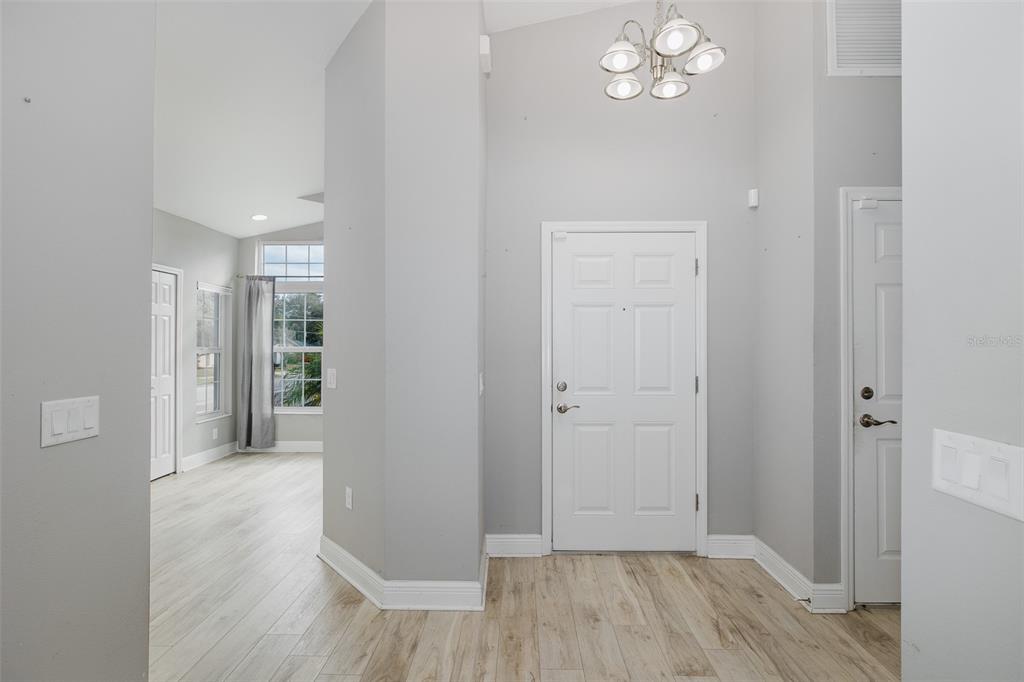 6823 Crossbow Lane New Port Richey, FL 34653 - Photo 4 of 25 a view of a hallway with wooden floor