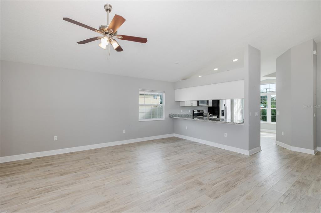 6823 Crossbow Lane New Port Richey, FL 34653 - Photo 8 of 25 wooden floor in an empty room with a window