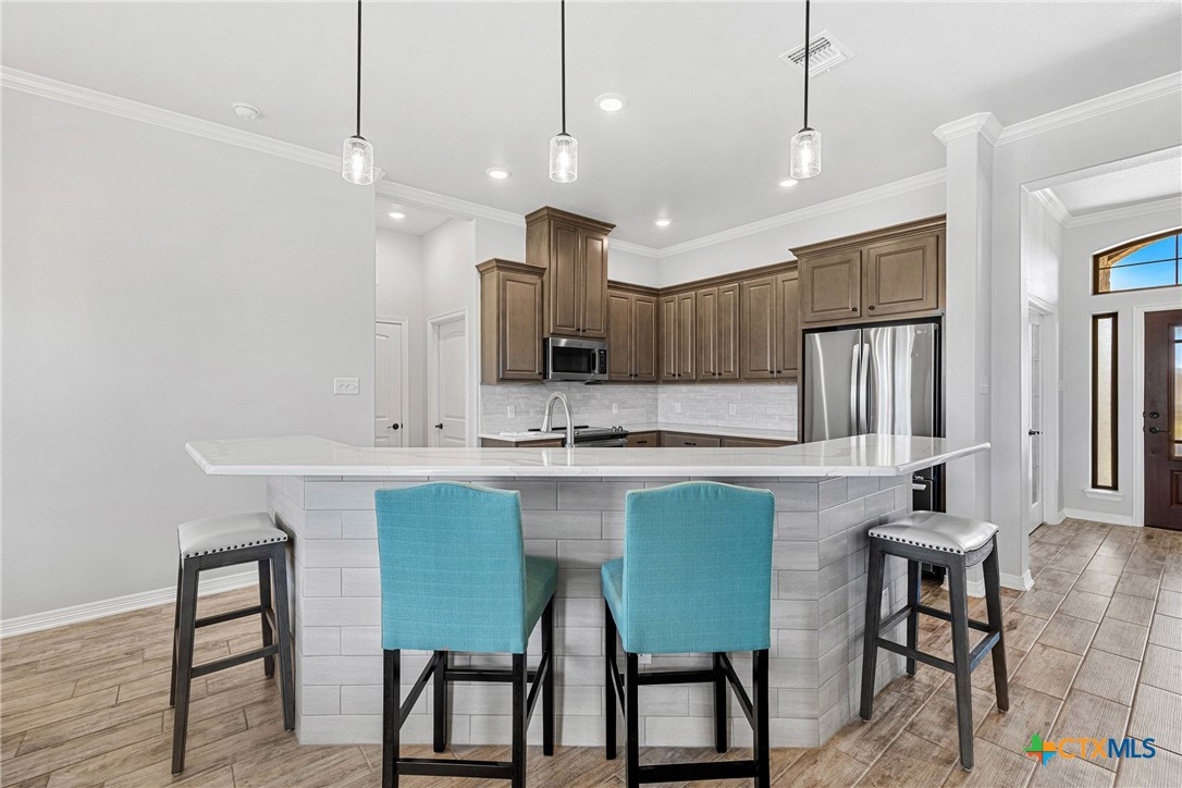 5513 Hollow Loop Salado, TX 76571 - Photo 11 of 37 a kitchen with cabinets and chairs