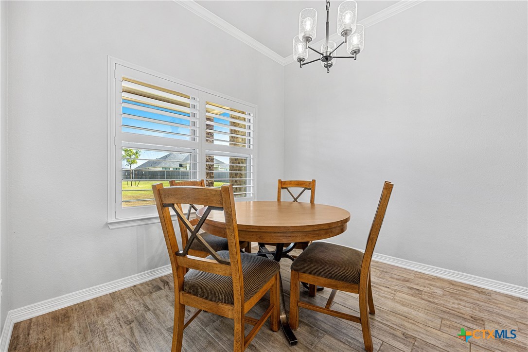 5513 Hollow Loop Salado, TX 76571 - Photo 14 of 37 a view of a dining room with furniture window and wooden floor