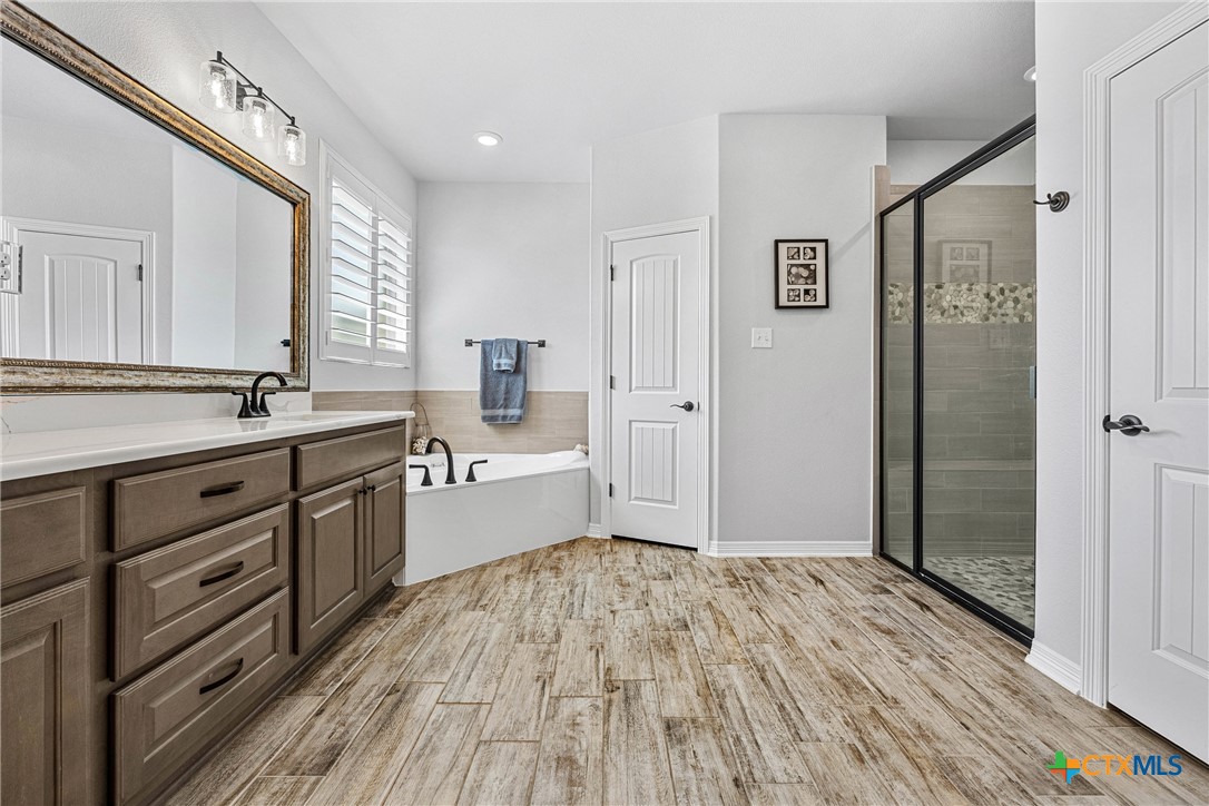 5513 Hollow Loop Salado, TX 76571 - Photo 22 of 37 a spacious bathroom with a double vanity sink a mirror and a shower