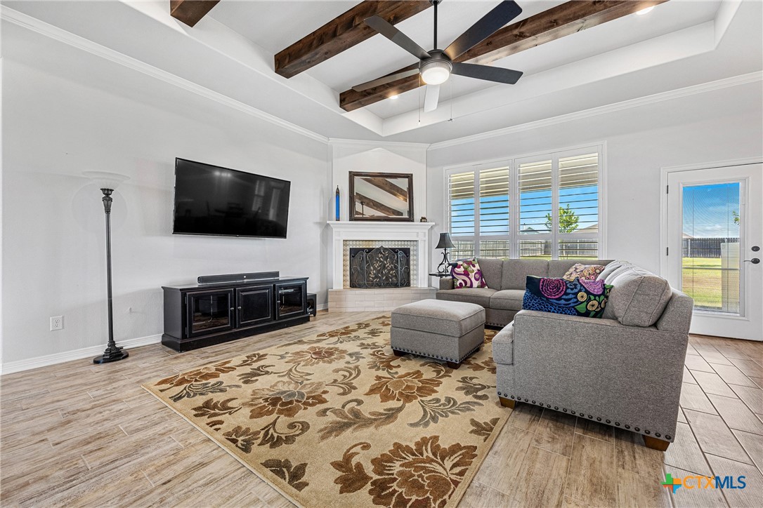 5513 Hollow Loop Salado, TX 76571 - Photo 10 of 37 a living room with furniture a fireplace and a flat screen tv