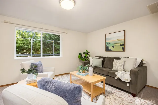 a living room with furniture and a large window