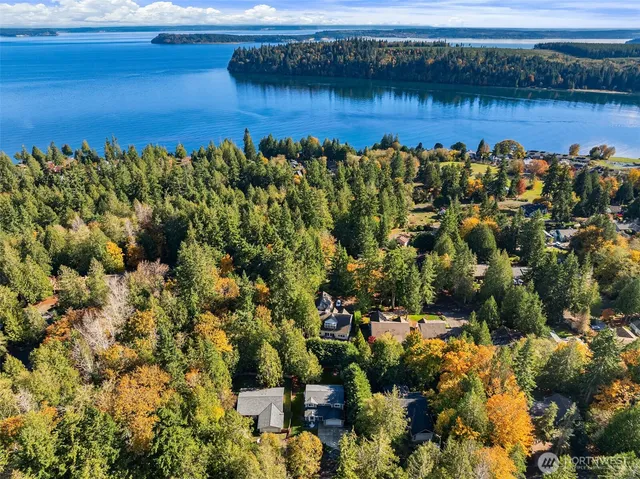 a view of a lake with a house and a mountain view
