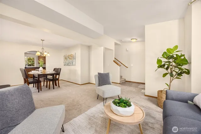 a living room with furniture potted plant and a chandelier