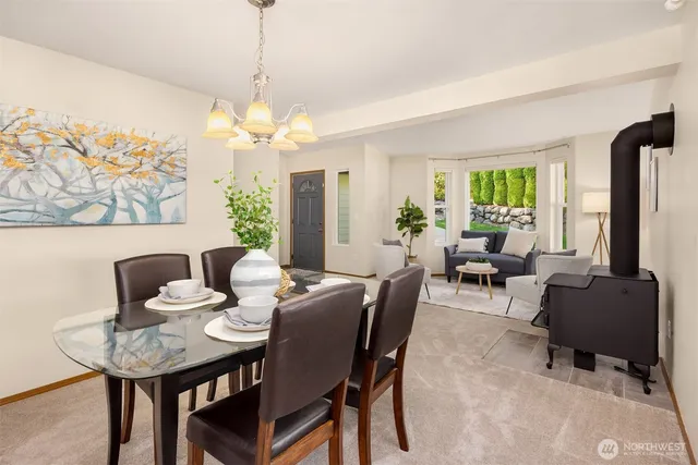 a view of a dining room with furniture and a chandelier