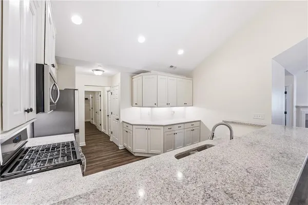 a spacious bathroom with a double vanity sink a mirror and bathtub
