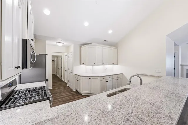 a spacious bathroom with a double vanity sink a mirror and bathtub
