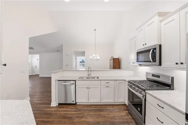 a kitchen with a sink stove and microwave