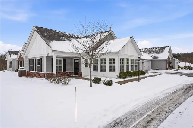 a view of a house with yard and sitting area
