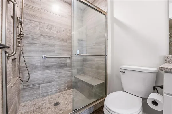 a white toilet next to a bathroom