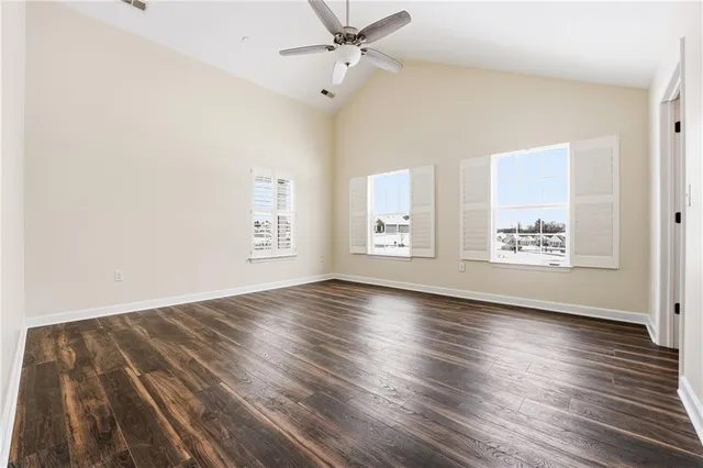 wooden floor in an empty room with a window