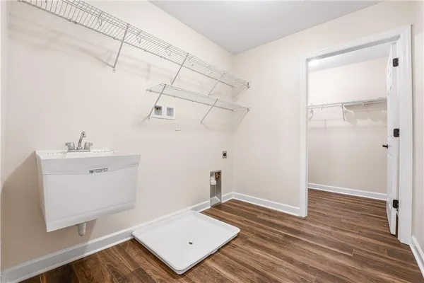 a view of a room with wooden floor