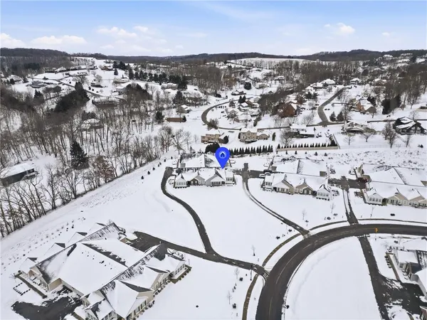 an aerial view of a swimming pool with outdoor seating