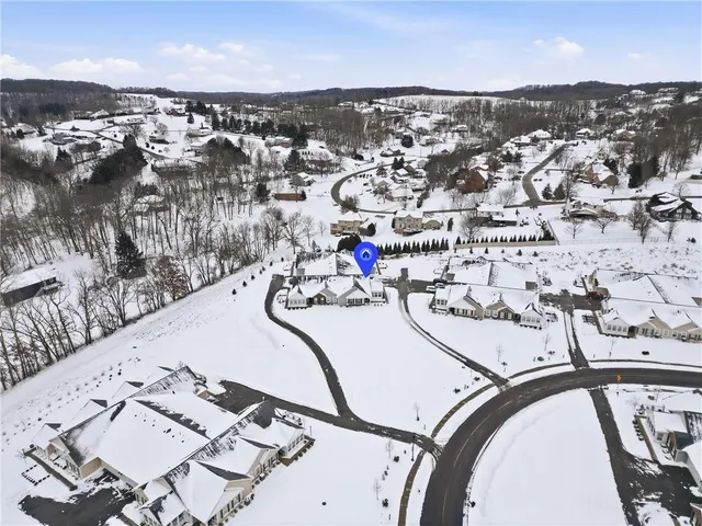 an aerial view of a swimming pool with outdoor seating