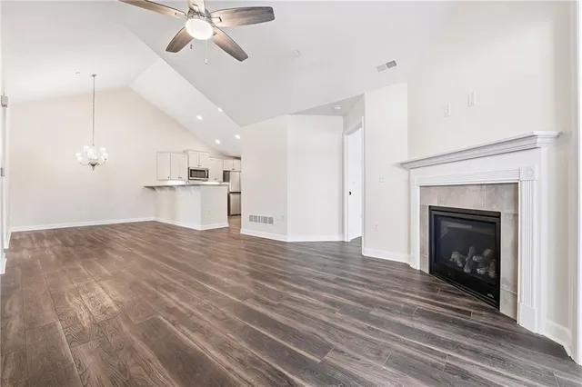 a view of empty room with wooden floor and fireplace