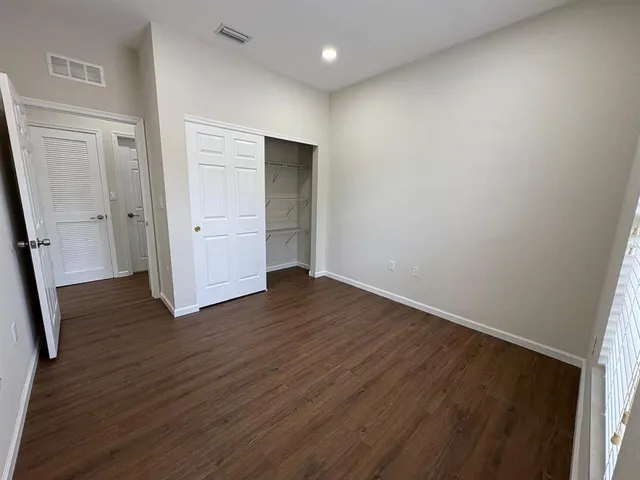 a view of kitchen with wooden floor and electronic appliances