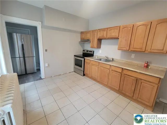 a kitchen with a sink cabinets and appliances