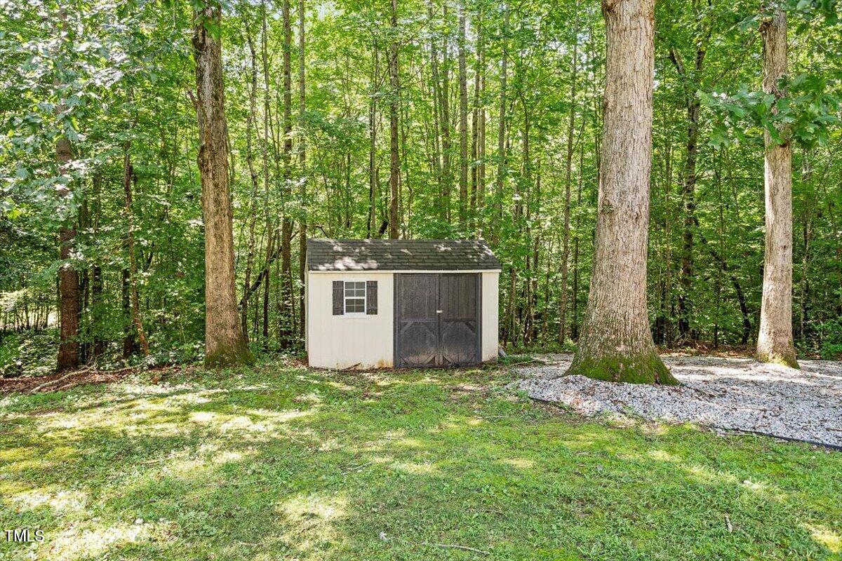 5112 Solemn Grove Road Garner, NC 27529 - Photo 12 of 56 a big yard with large trees and plants