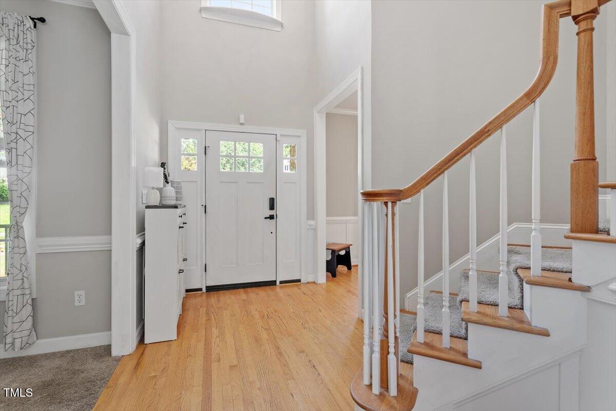 5112 Solemn Grove Road Garner, NC 27529 - Photo 14 of 56 a view of entryway with wooden floor and stairs