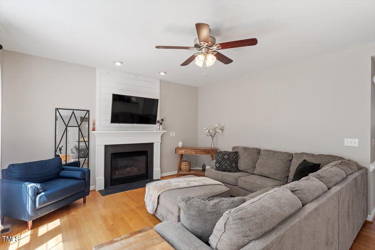 5112 Solemn Grove Road Garner, NC 27529 - Photo 15 of 56 a living room with furniture a fireplace