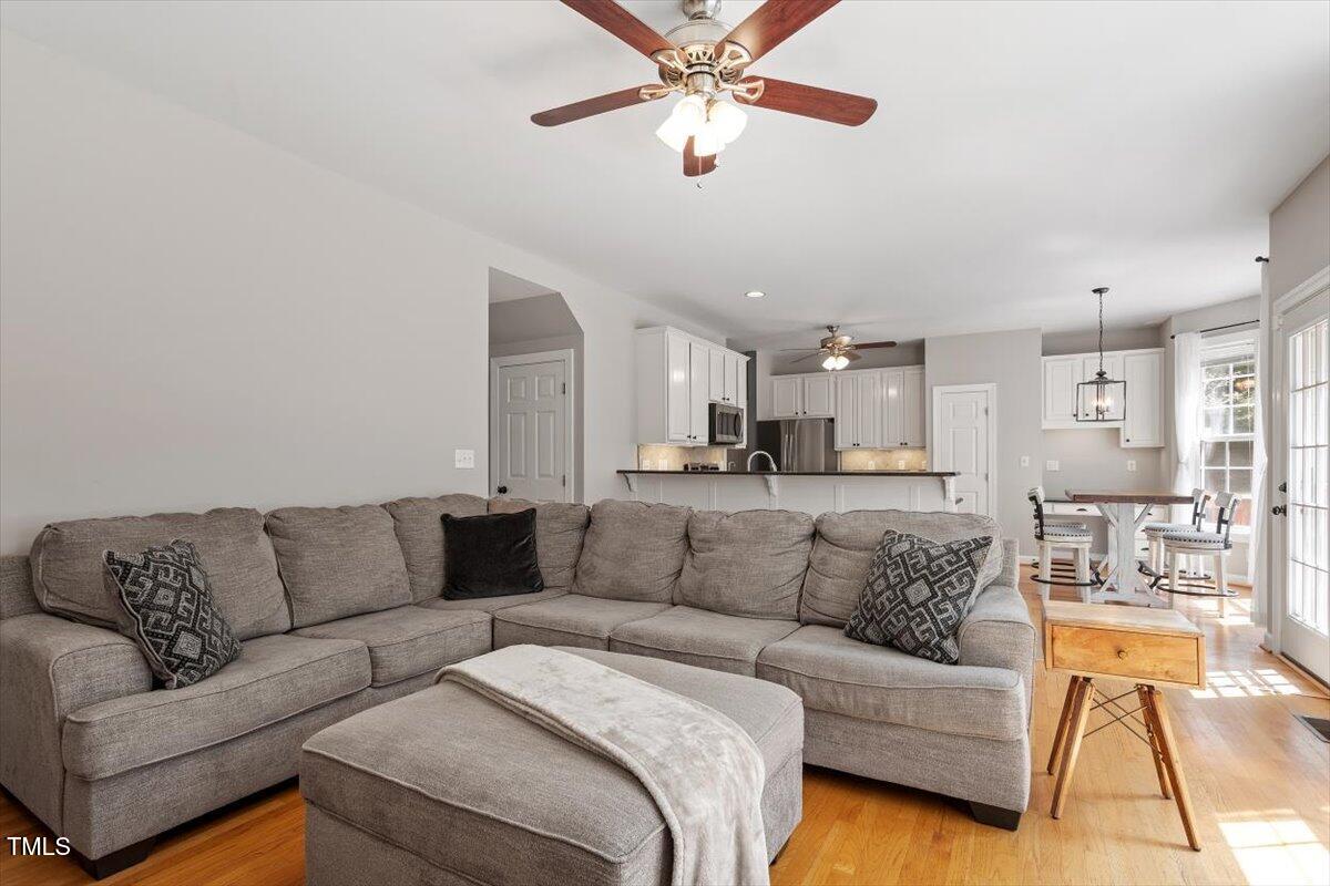 5112 Solemn Grove Road Garner, NC 27529 - Photo 16 of 56 a living room with furniture white walls and a couch