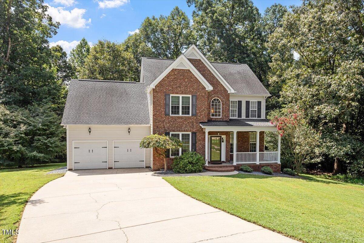 5112 Solemn Grove Road Garner, NC 27529 - Photo 2 of 56 a front view of a house with a garden