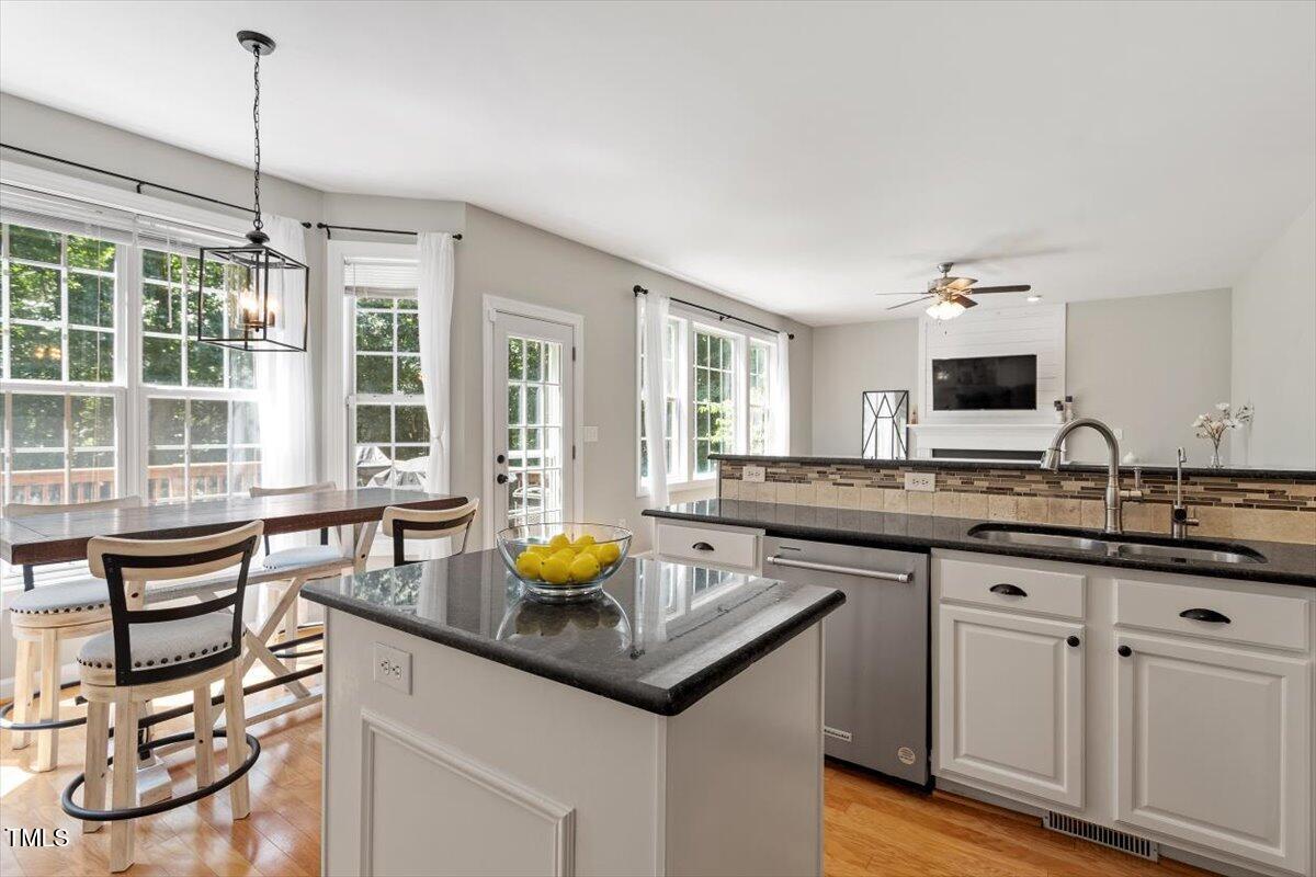 5112 Solemn Grove Road Garner, NC 27529 - Photo 22 of 56 a kitchen with a sink a counter space and dining table